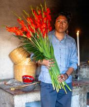 A man holding a large bunch of flowers