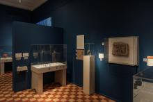 View of a darkened gallery with Egyptian and Nubian artefacts